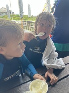 Ocean Club kids sharing ice cream after a session