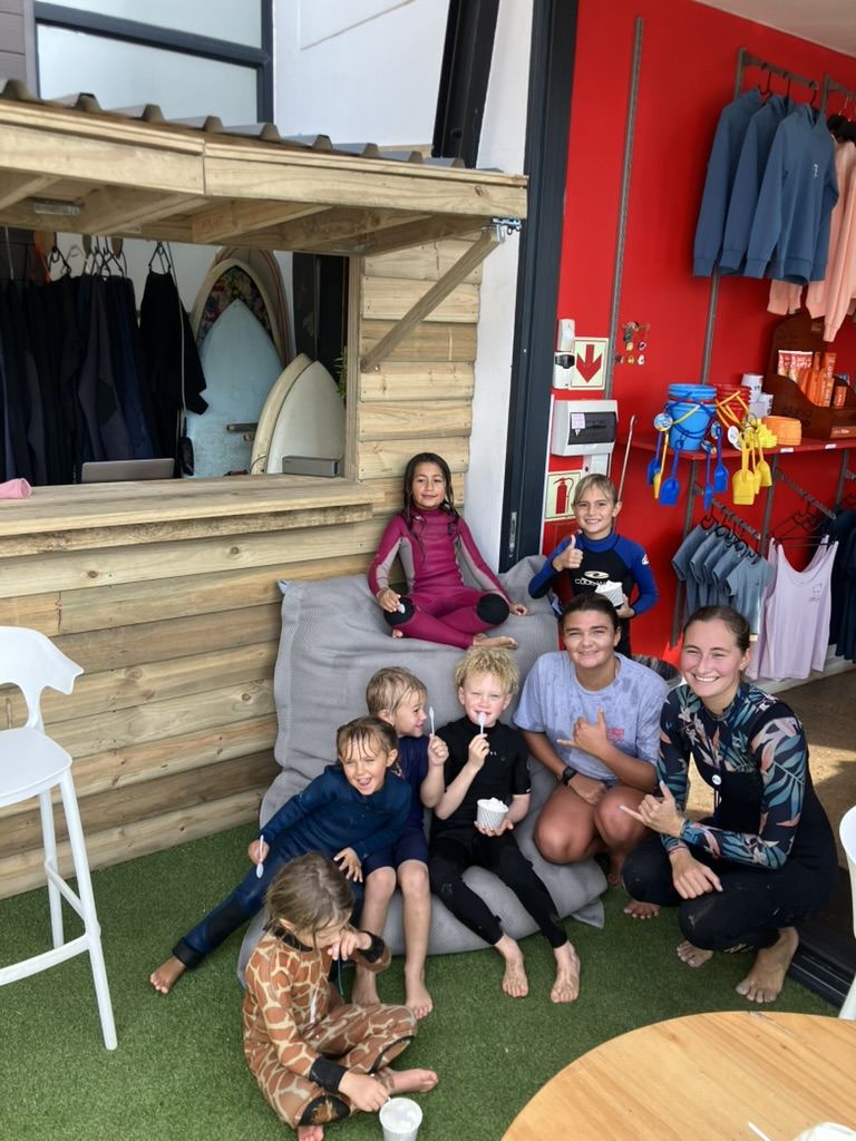Kids relaxing at the Radical Rippers kiosk after a session