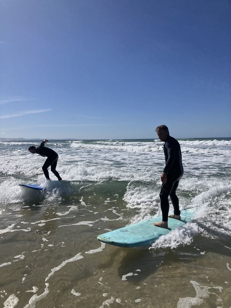 Surfers riding waves during a Radical Rippers lesson